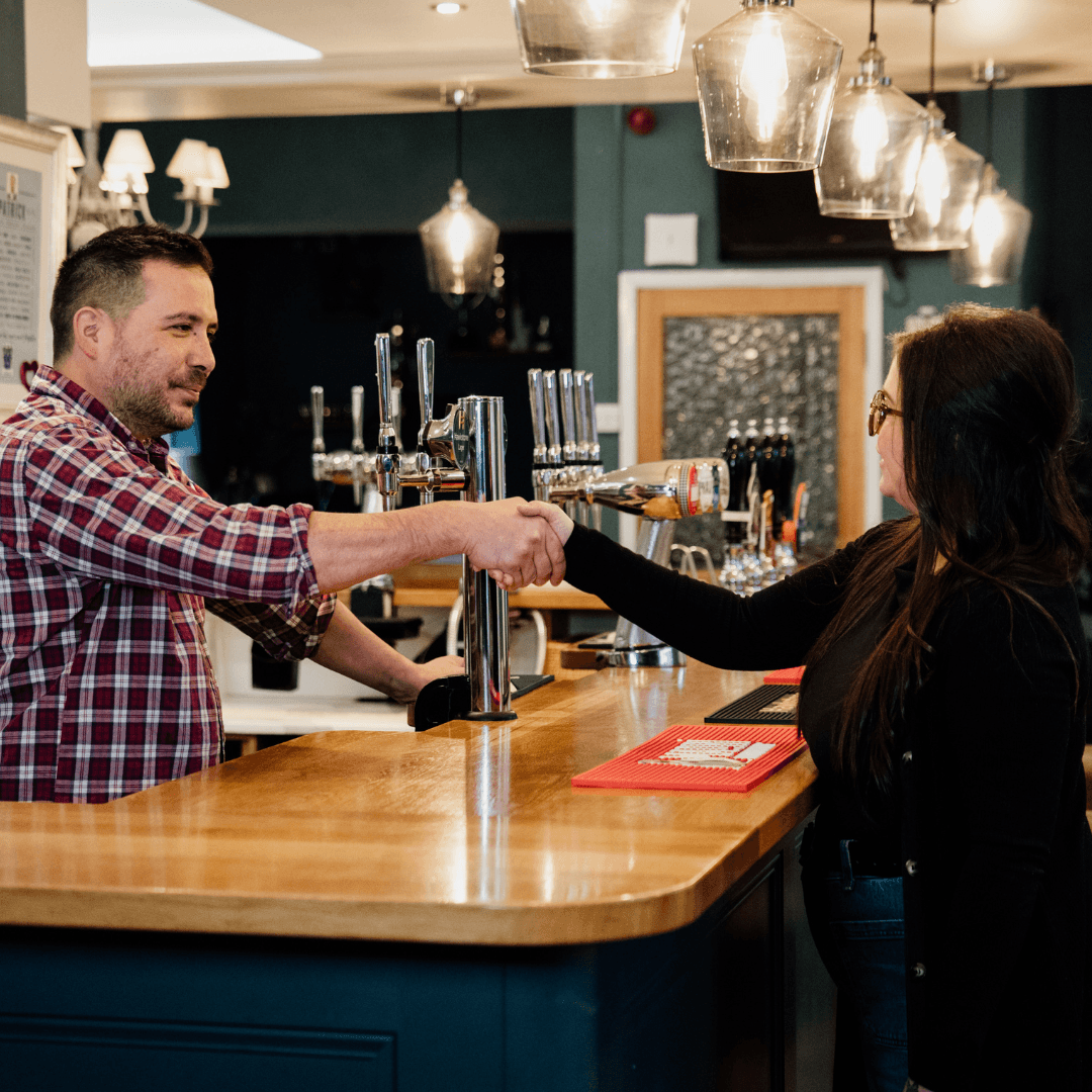 Happy merchant with payment terminal